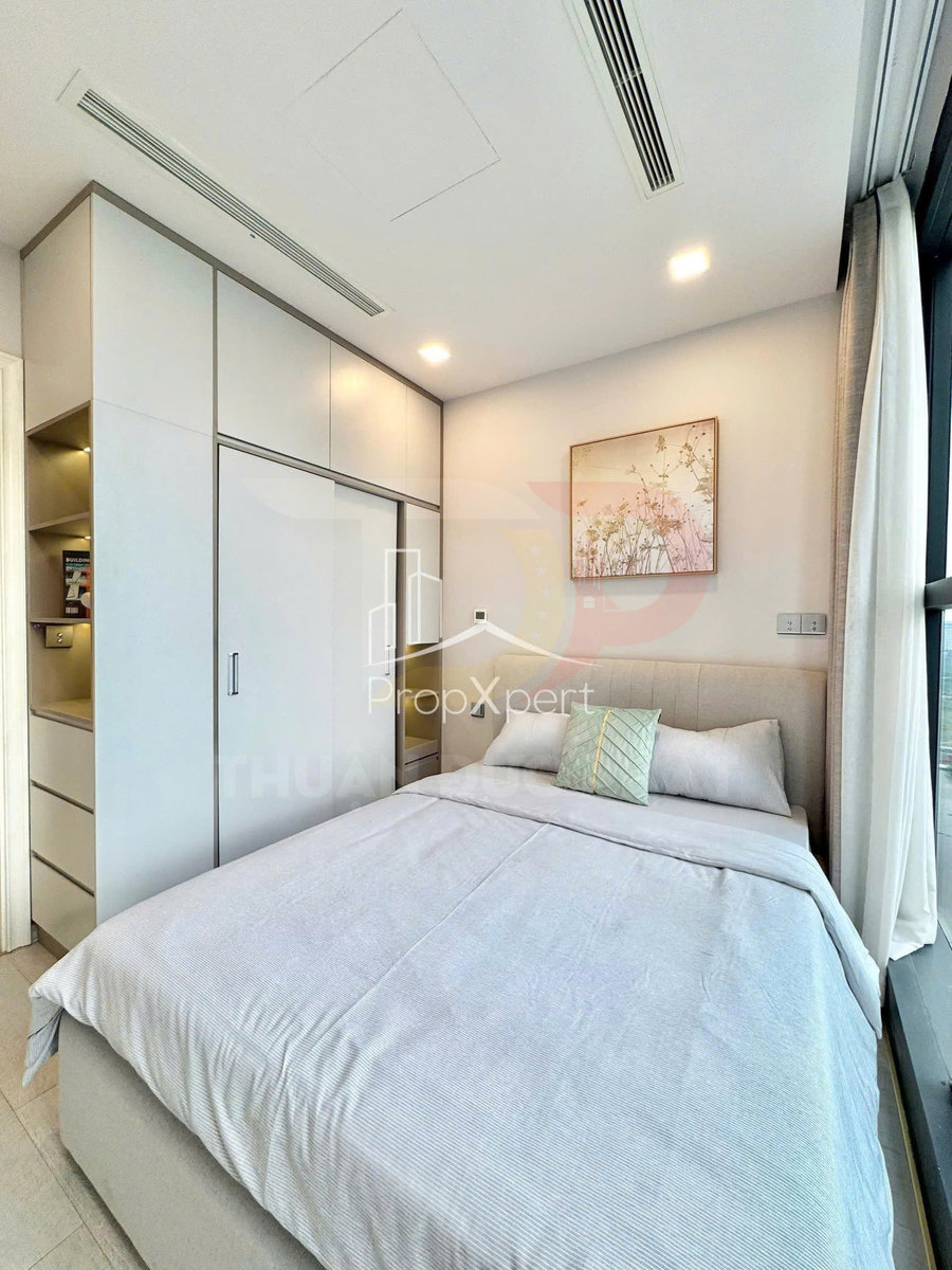 Phòng ngủ nhỏ hiện đại với giường đôi ga màu sáng, tủ quần áo âm tường và cửa sổ kính lớn tràn ánh sáng