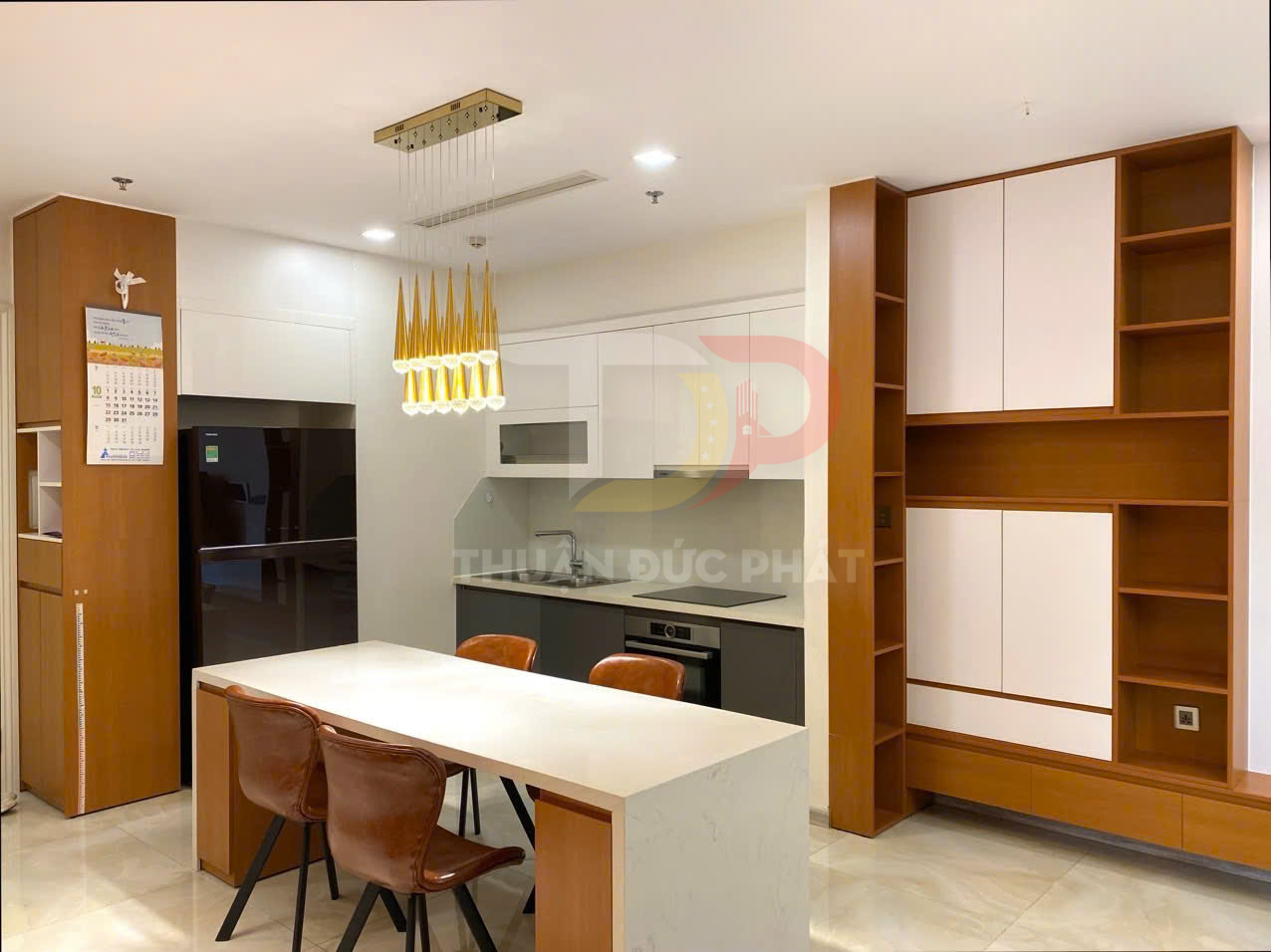 Nội thất bếp hiện đại với tủ gỗ, bàn đảo đá trắng, ghế da nâu và đèn thả trang trí màu vàng