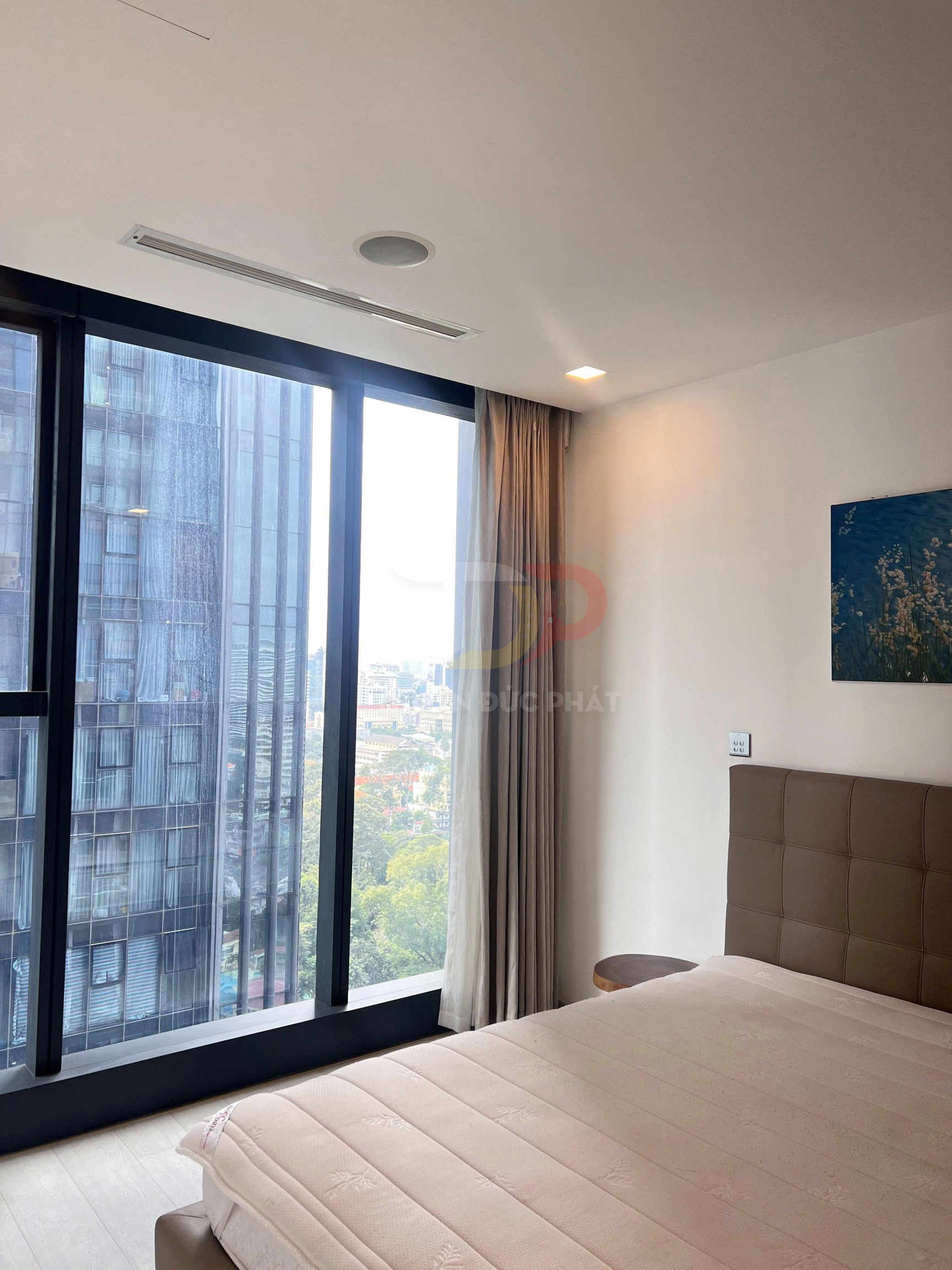 Phòng ngủ chung cư hiện đại với giường nệm lớn cạnh cửa sổ kính toàn cảnh thành phố