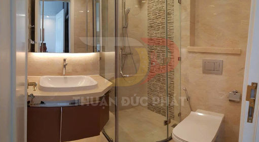 Phòng tắm hiện đại với bồn rửa mặt, buồng tắm kính và bồn cầu sứ màu trắng