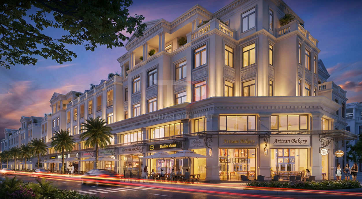 Dãy shophouse tân cổ điển sang trọng buổi tối với quán cà phê và tiệm bánh Artisan Bakery sầm uất